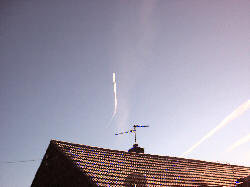 Vapour trails over house